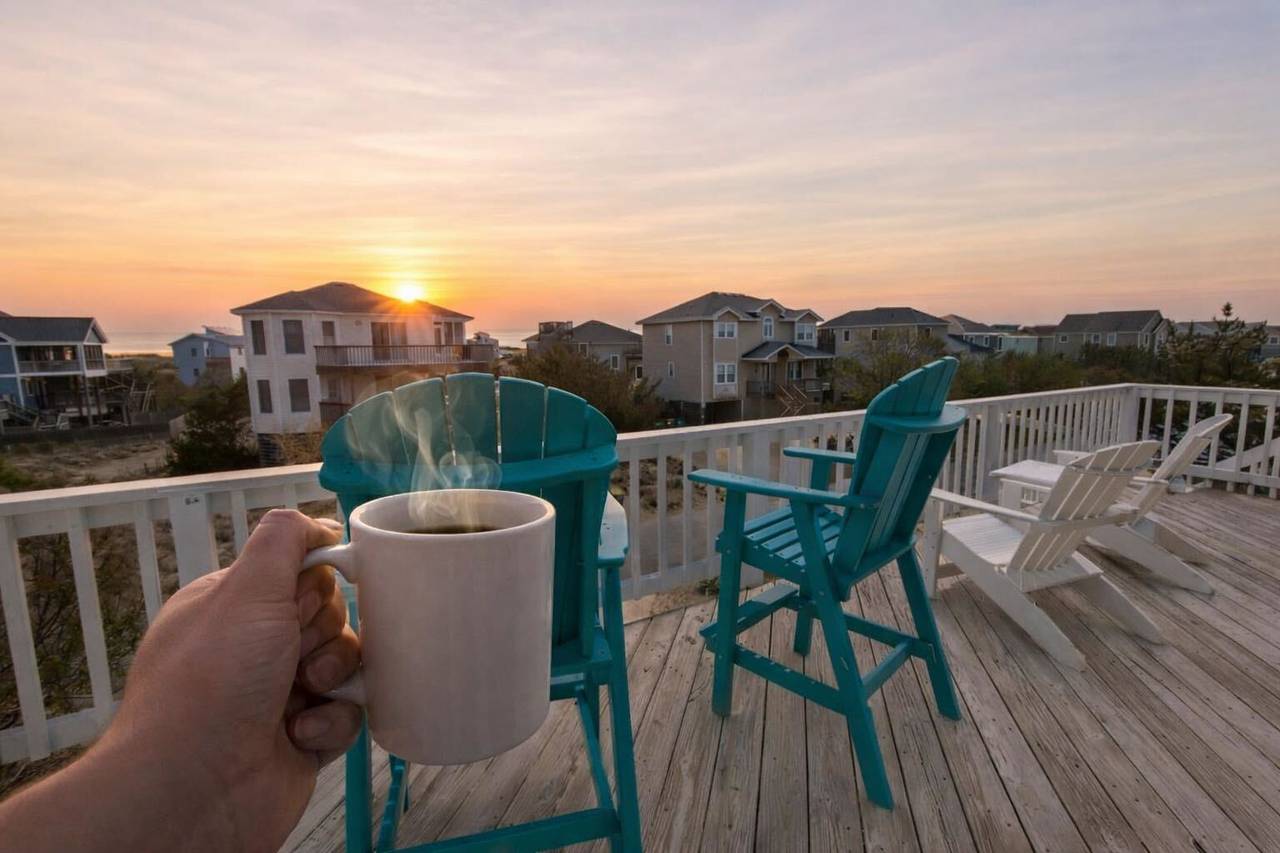 Outer Banks vacation rental deck with sunrise over the ocean views