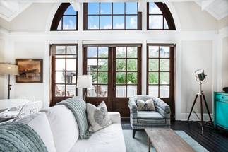 Large windows flood the stylish living area with natural light. Large windows flood the stylish living area with natural light.