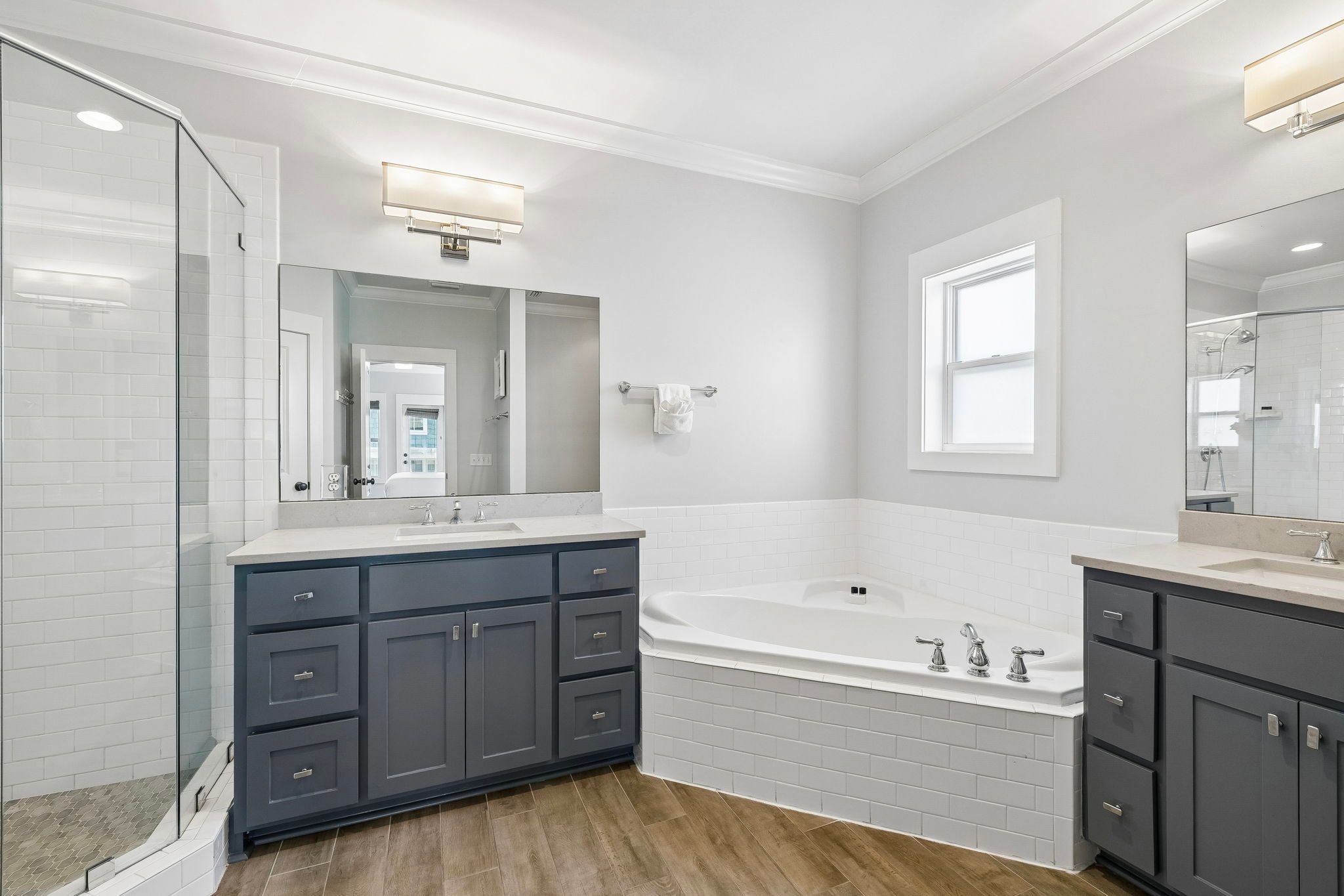 Primary en-suite with a jetted tub and dual vanities