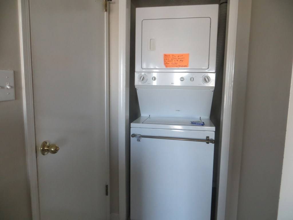 stack washer and dryer in unit for your convenience, also with a starter laundry washing powder packet.
