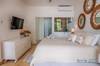 Primary bedroom with a king bed and a single trundle bed