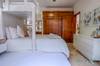 Guest bedroom with a King bed, single trundle bed and single bun