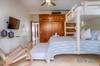 Guest bedroom with a King bed, single trundle bed and single bun