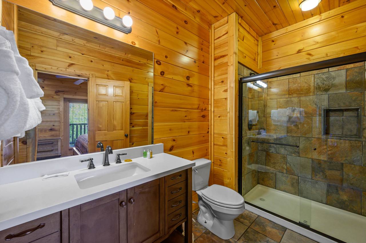 Lower level en-suite bathroom, also accessible to the game room. Lower level en-suite bathroom, also accessible to the game room.
