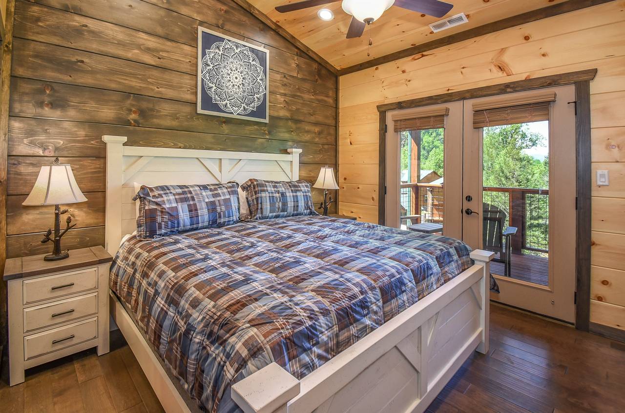 Upper-level king bedroom with private en-suite bath (3) & deck Upper-level king bedroom with private en-suite bath (3) & deck