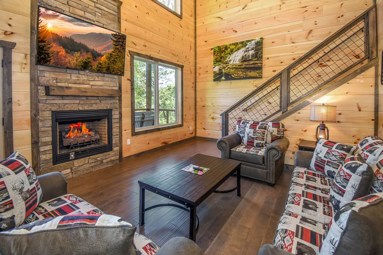 Cozy living room with stone electric fireplace, TV, & sleeper so Cozy living room with stone electric fireplace, TV, & sleeper so