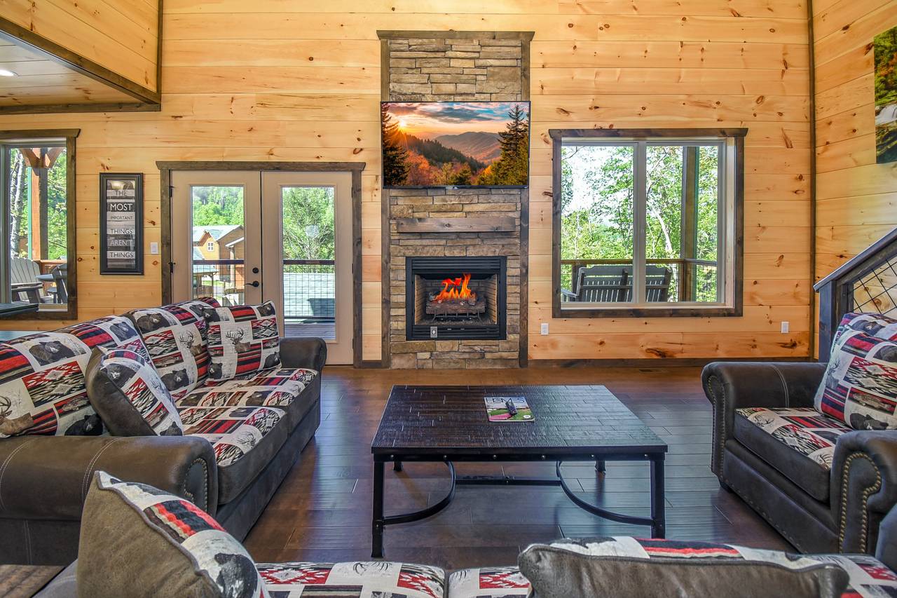 Cozy living room with stone electric fireplace, TV, & sleeper so Cozy living room with stone electric fireplace, TV, & sleeper so