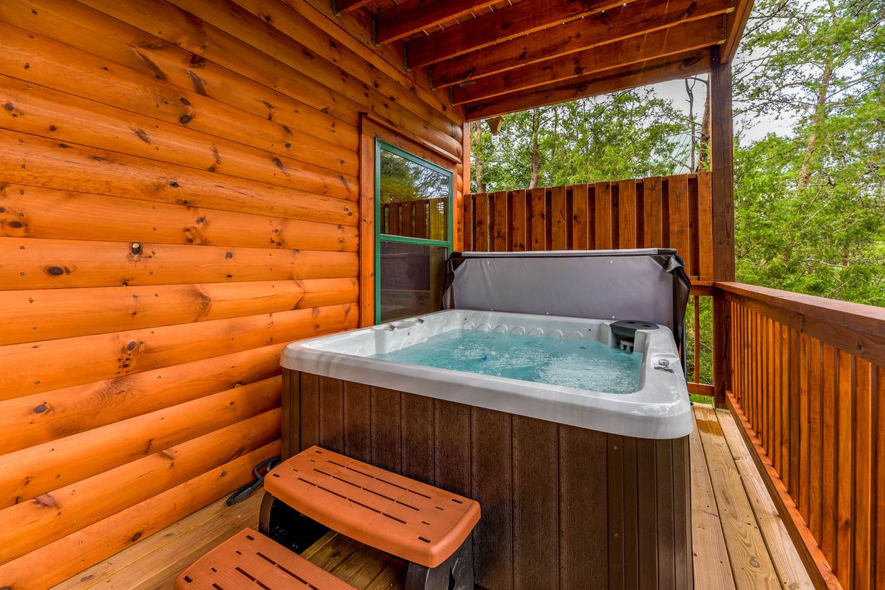 Lower deck with hot tub for 5 & peaceful wooded views Lower deck with hot tub for 5 & peaceful wooded views