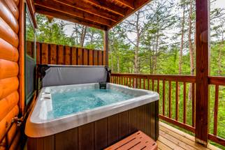 Lower deck with hot tub for 5 & peaceful wooded views Lower deck with hot tub for 5 & peaceful wooded views