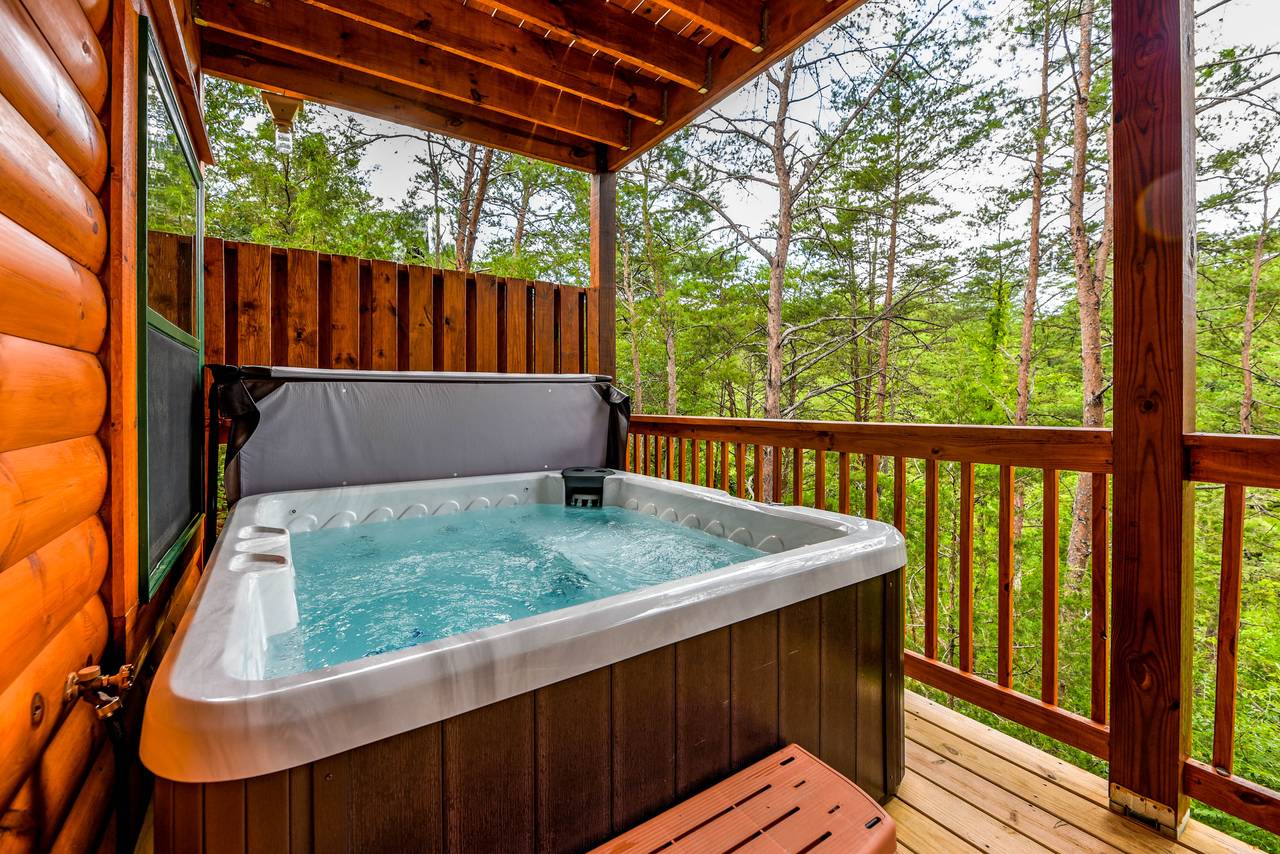 Lower deck with hot tub for 5 & peaceful wooded views Lower deck with hot tub for 5 & peaceful wooded views
