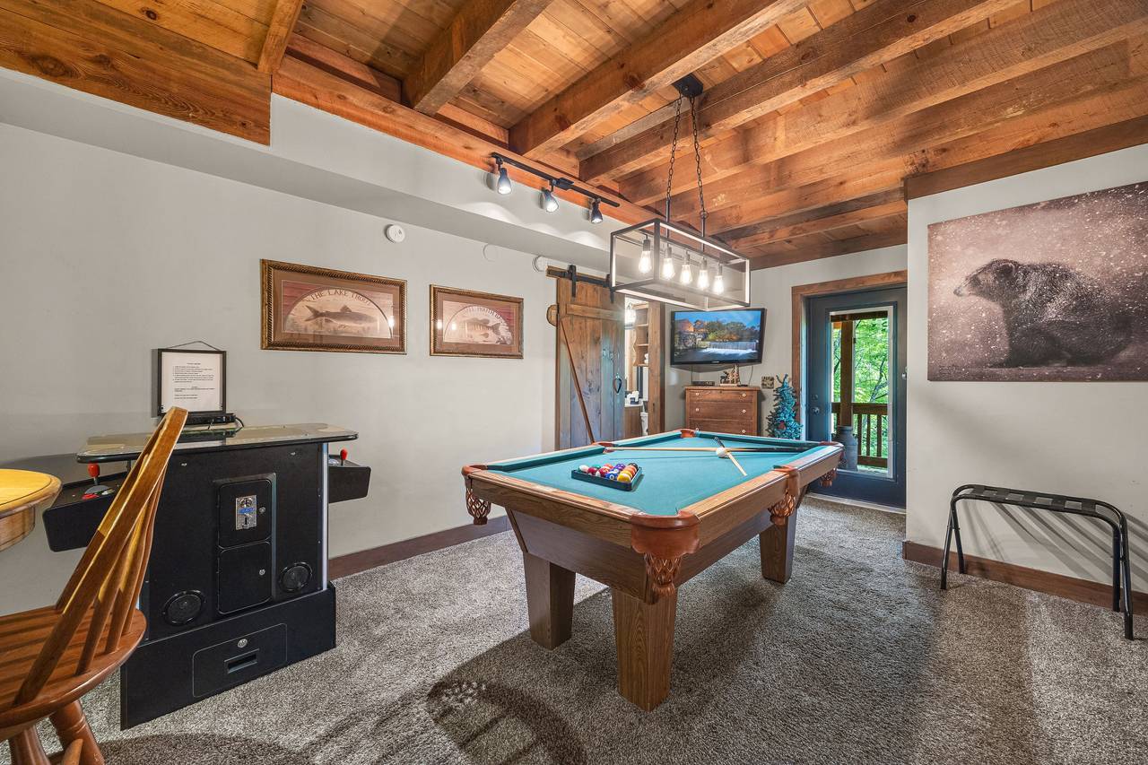 Lower level game room with bunk bed, pool table, & arcade Lower level game room with bunk bed, pool table, & arcade