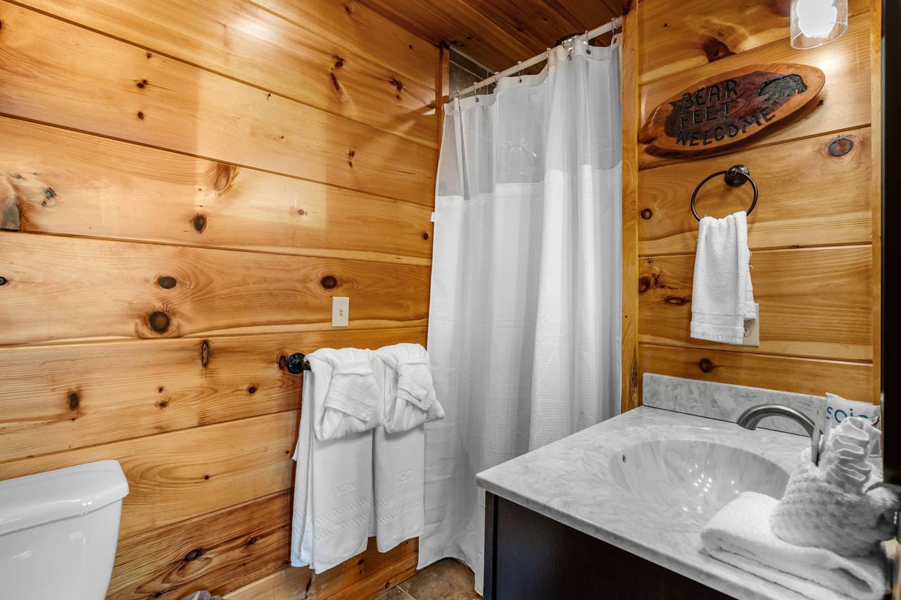 Shared bath with walk-in shower connects game room & bunks Shared bath with walk-in shower connects game room & bunks