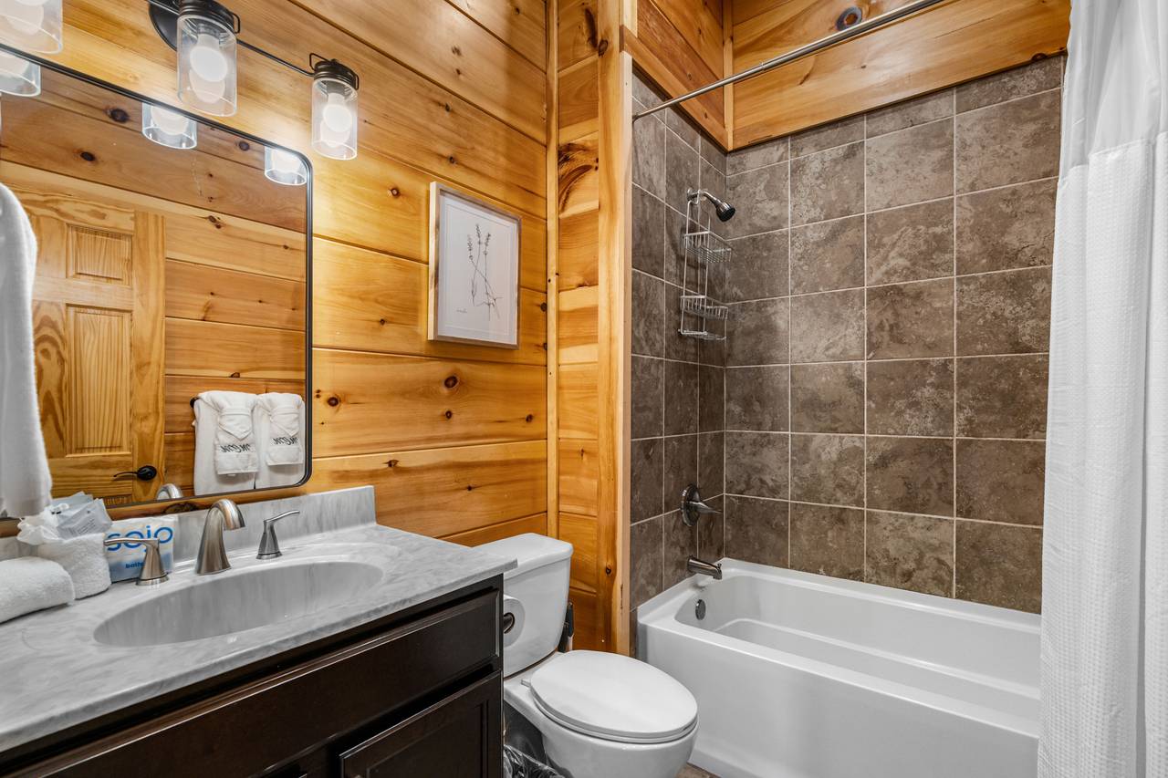 Private ensuite bath with tub/shower combo for queen bunks Private ensuite bath with tub/shower combo for queen bunks