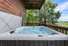 Relaxing 6-person hot tub with scenic backdrop Relaxing 6-person hot tub with scenic backdrop