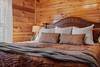 Main-level king bedroom with plush bedding Main-level king bedroom with plush bedding