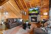 Cozy living room with fireplace, TV, & unforgettable views Cozy living room with fireplace, TV, & unforgettable views