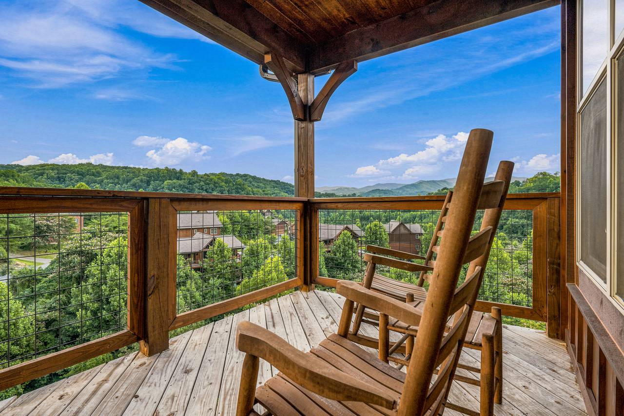 Private decks feature rocking chairs and mountain views. Private decks feature rocking chairs and mountain views.