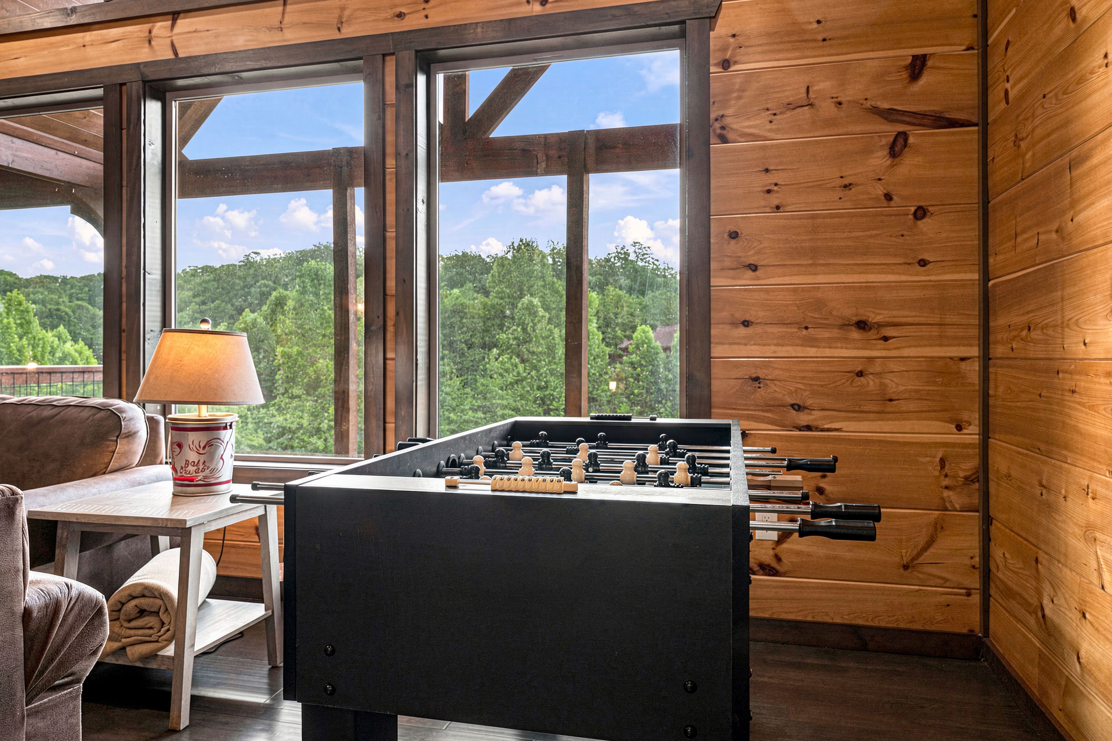 Upper level living room with arcade game and foosball.