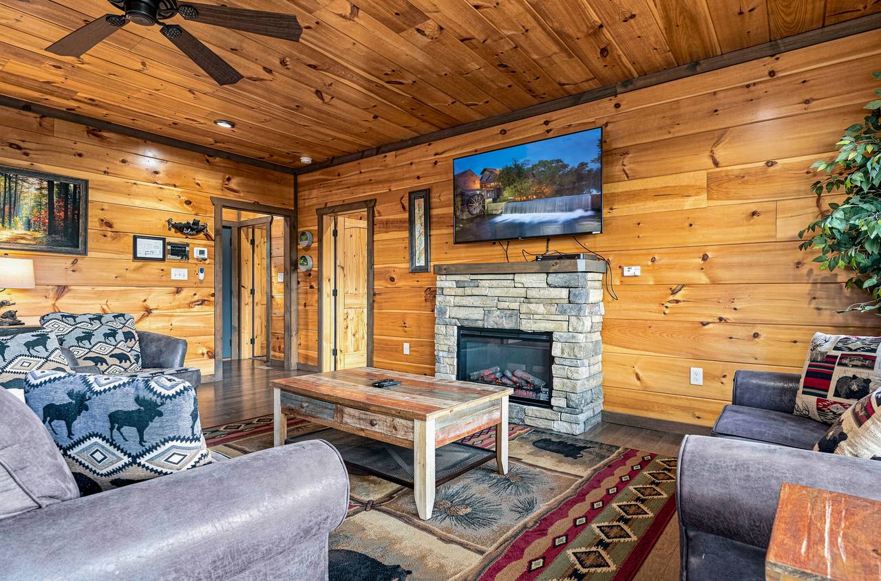 Main living room with electric fireplace and flat-screen TV. Main living room with electric fireplace and flat-screen TV.