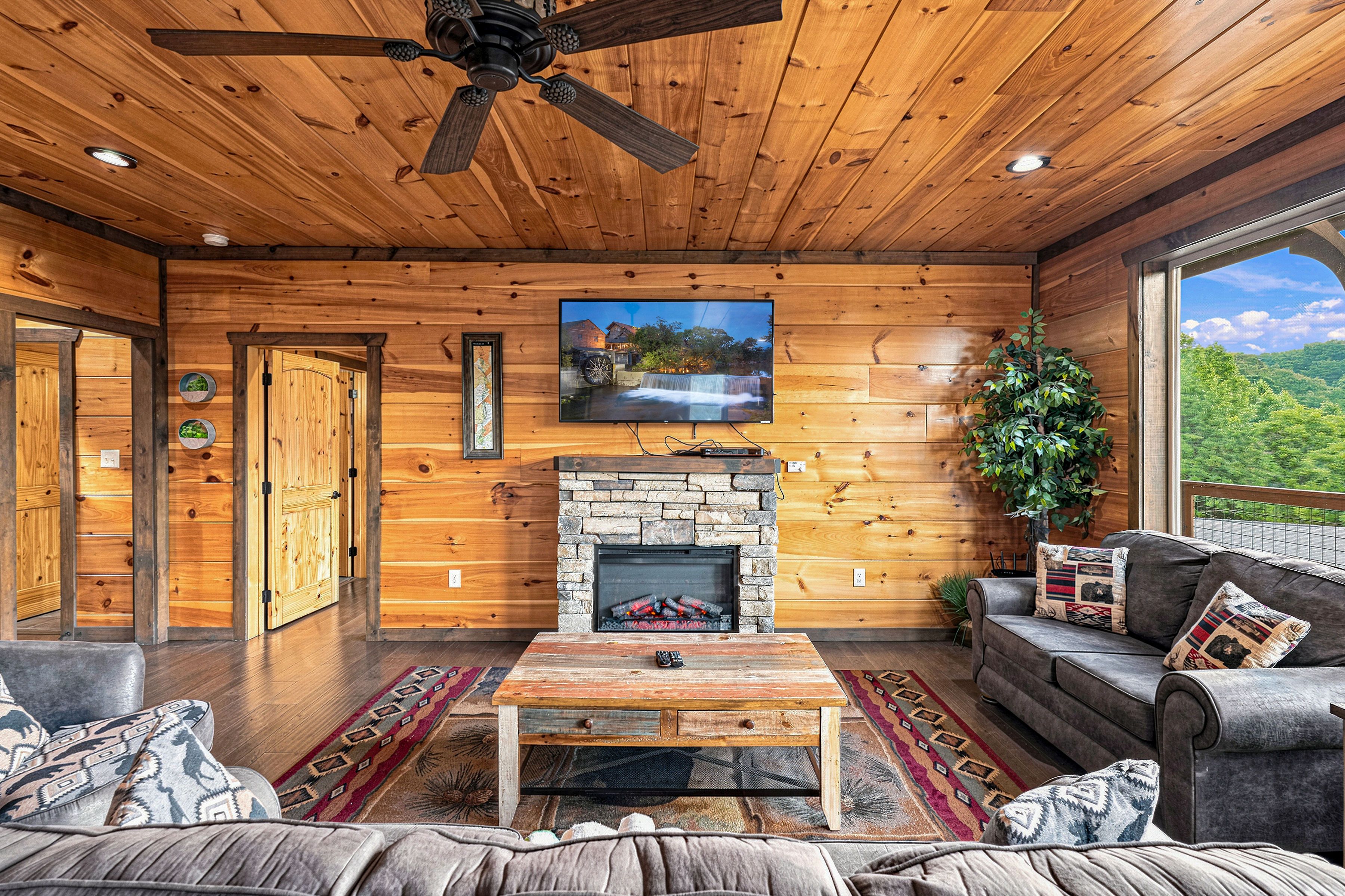 Main living room with electric fireplace and flat-screen TV.