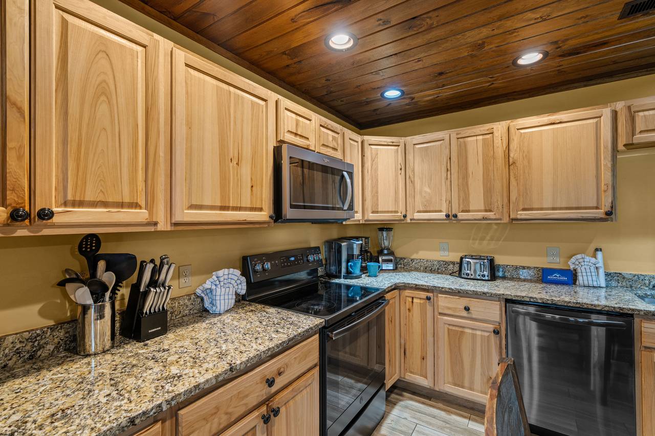 Spacious kitchen w/ smooth cooktop & large fridge Spacious kitchen w/ smooth cooktop & large fridge