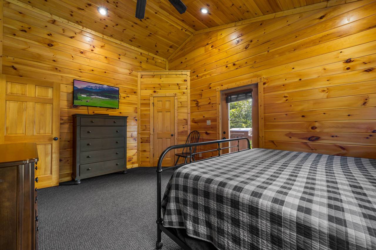 Bedroom 1: King bed, deck entrance, TV Bedroom 1: King bed, deck entrance, TV