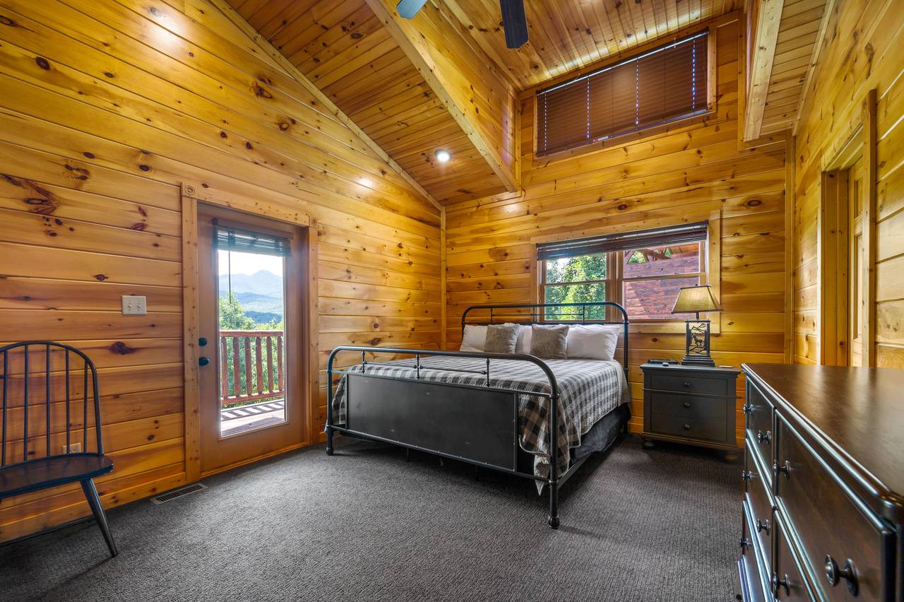 Bedroom 1: King bed, deck entrance, TV Bedroom 1: King bed, deck entrance, TV