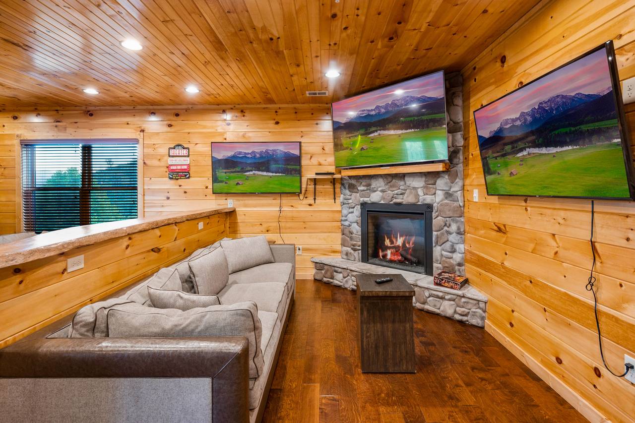Lower level game room entertainment area with 3 TVs & fireplace! Lower level game room entertainment area with 3 TVs & fireplace!