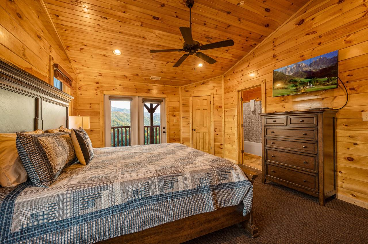 Bed 3: King bed, deck entrance, TV, and ensuite full bath Bed 3: King bed, deck entrance, TV, and ensuite full bath
