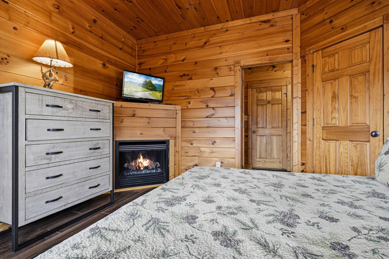 Lower-level king bedroom with fireplace, TV, & ensuite full bath Lower-level king bedroom with fireplace, TV, & ensuite full bath