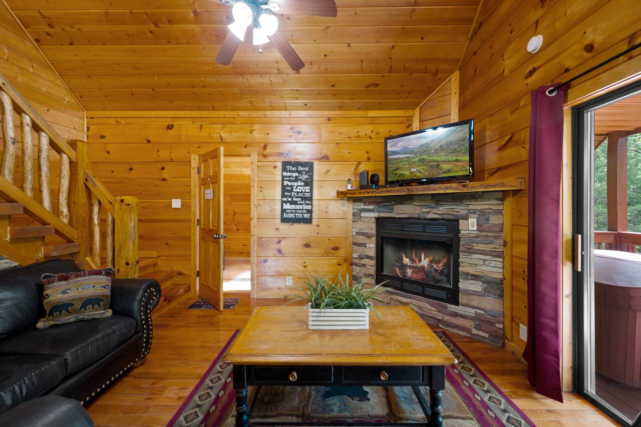 Spacious living room offers fireplace, TV, and sleeper sofa Spacious living room offers fireplace, TV, and sleeper sofa