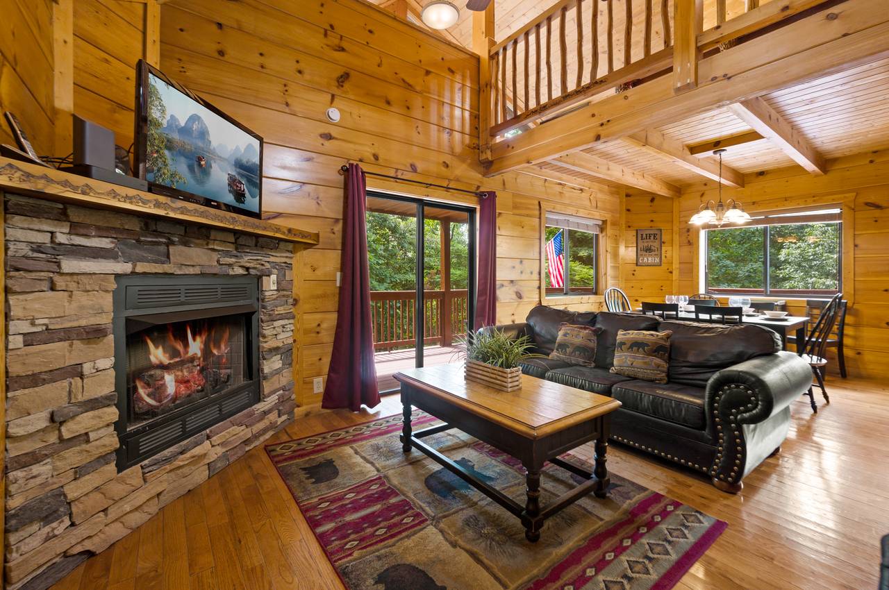 Spacious living room offers fireplace, TV, and sleeper sofa Spacious living room offers fireplace, TV, and sleeper sofa