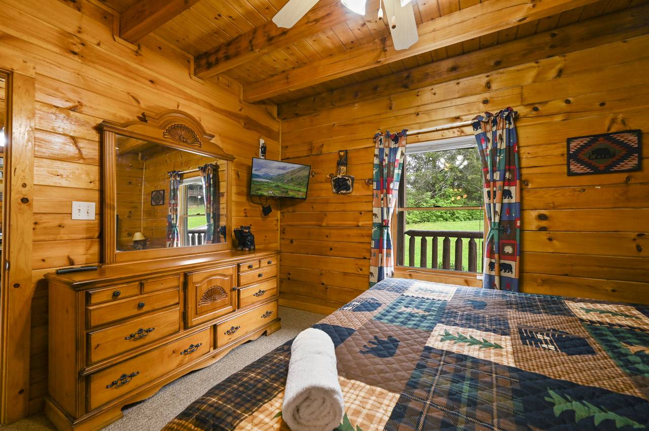 <span class="name">Main level king bedroom with flat screen TV.</span> <span class="name">Main level king bedroom with flat screen TV.</span>