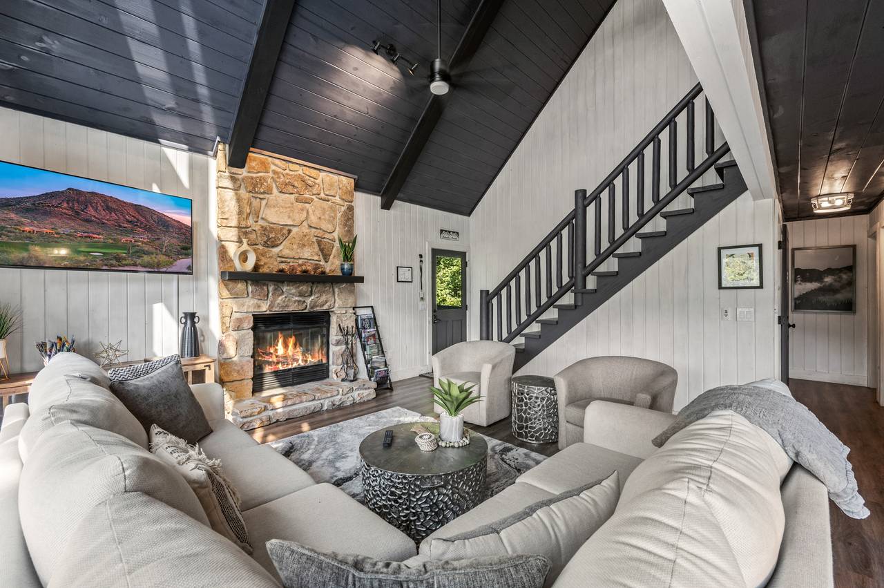 Living room with stone fireplace & views Living room with stone fireplace & views