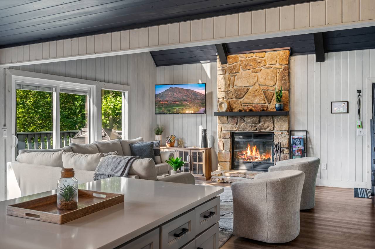 Living room with stone fireplace & views Living room with stone fireplace & views