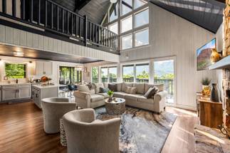 Living room with stone fireplace & views Living room with stone fireplace & views