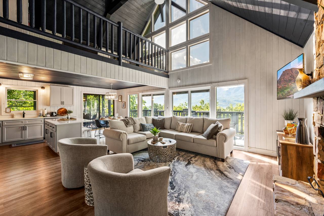 Living room with stone fireplace & views Living room with stone fireplace & views