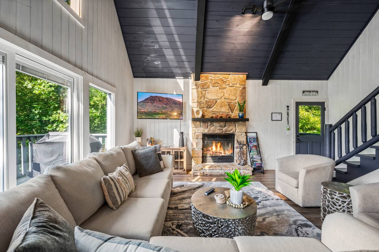 Living room with stone fireplace & views Living room with stone fireplace & views