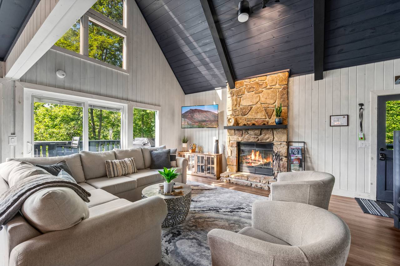Living room with stone fireplace & views Living room with stone fireplace & views