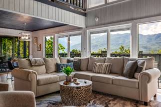 Living room with stone fireplace & views Living room with stone fireplace & views