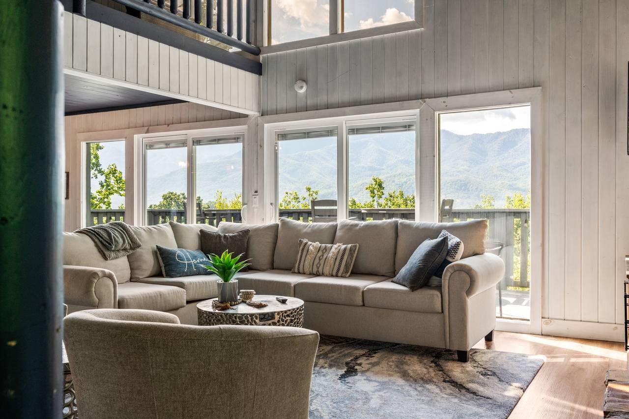 Living room with stone fireplace & views Living room with stone fireplace & views