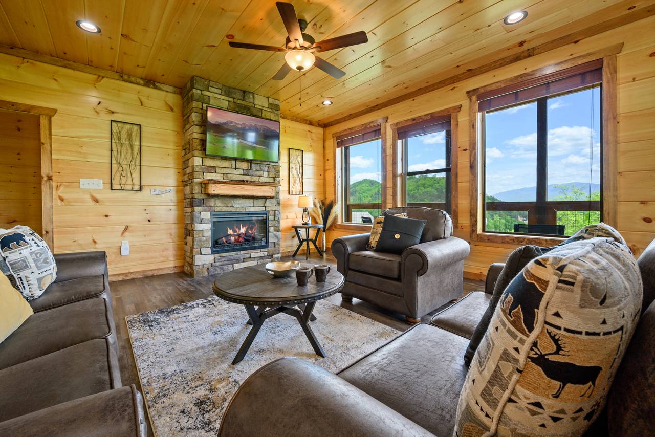 Spacious living room with views, fireplace, TV, and sleeper. Spacious living room with views, fireplace, TV, and sleeper.