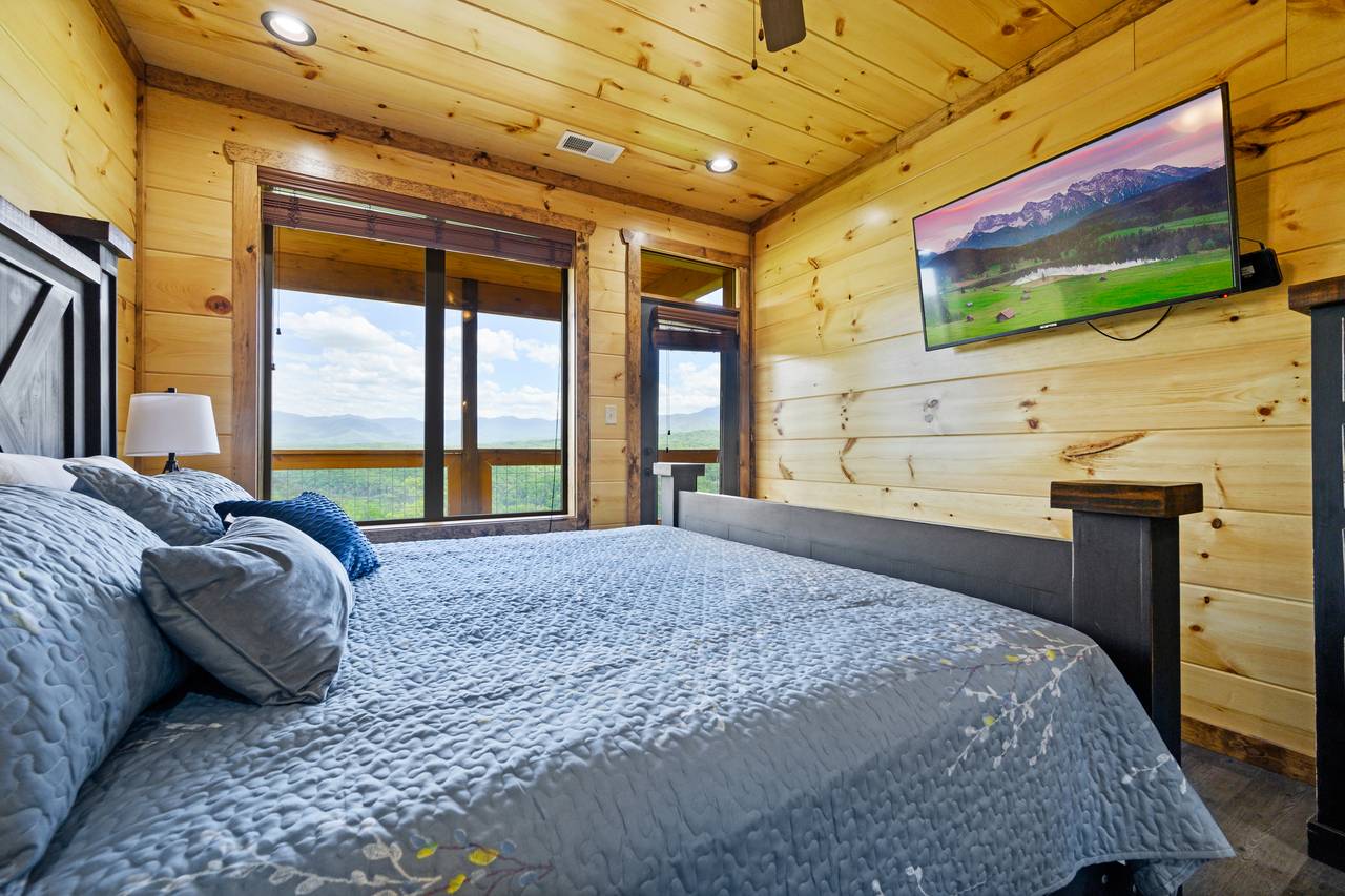 Bedroom 1: King bed, TV, and deck entrance. Bedroom 1: King bed, TV, and deck entrance.