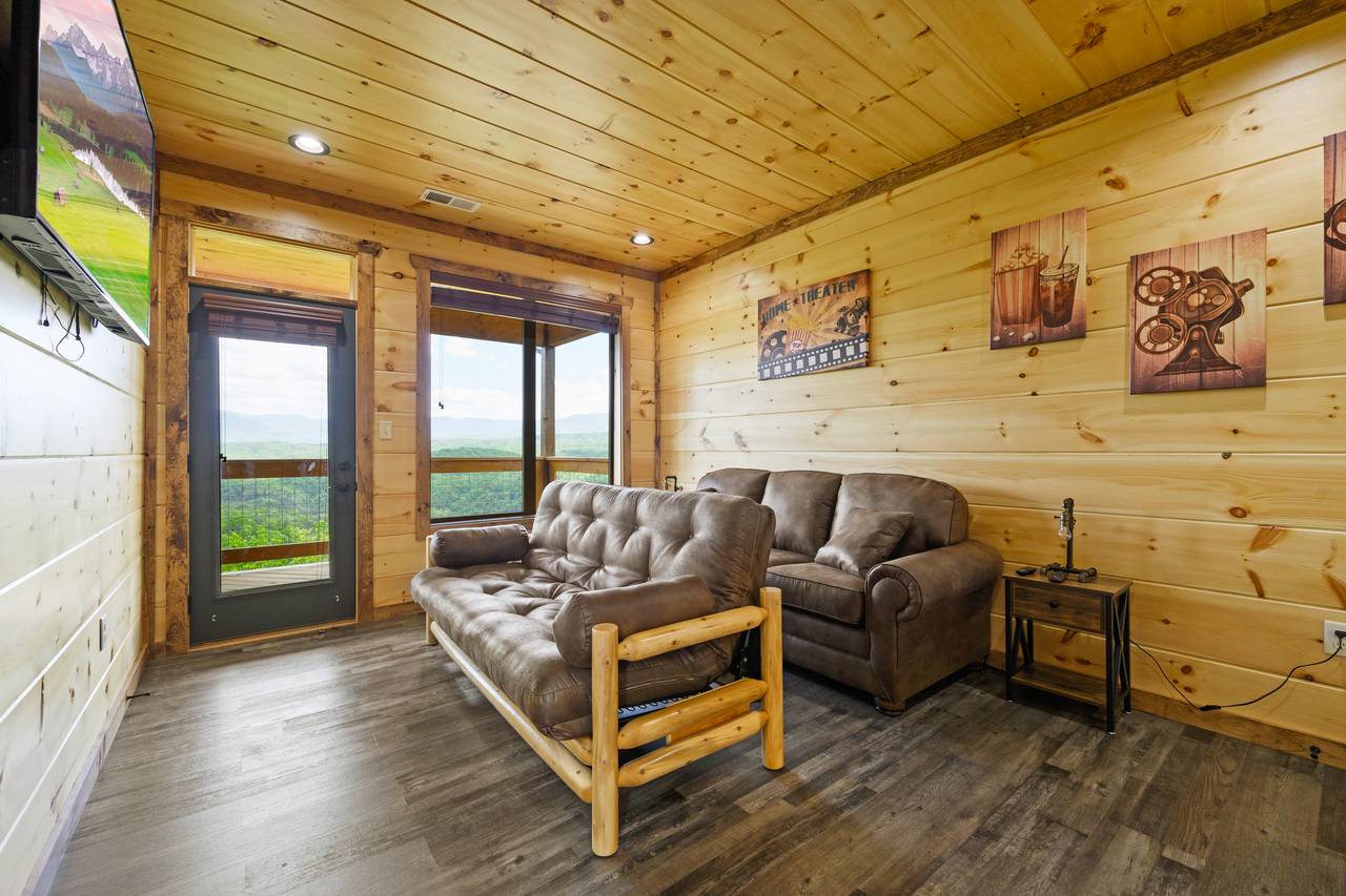 Bedroom 2/Theater Room with futon, half bath, & deck entrance. Bedroom 2/Theater Room with futon, half bath, & deck entrance.