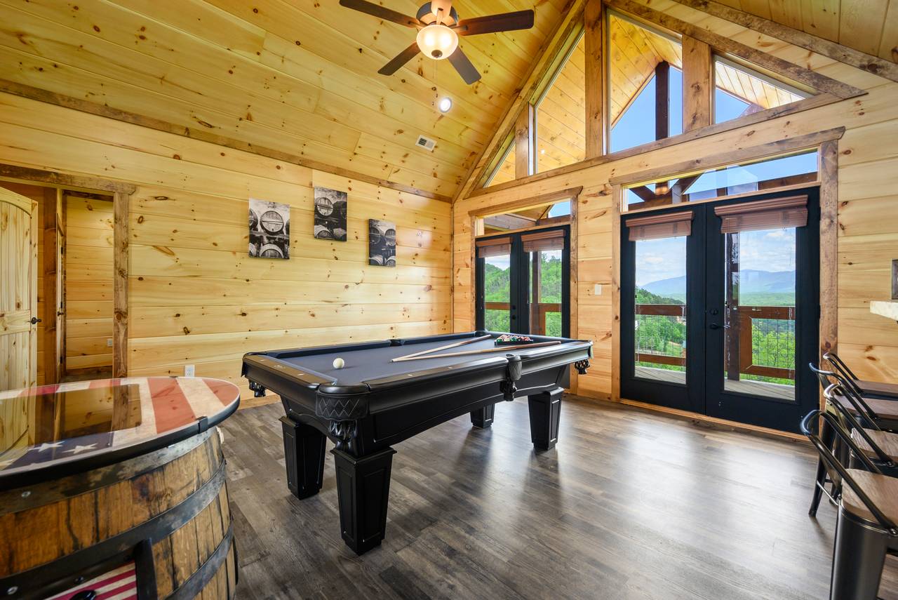 Game room with pool table and a pub style multi-cade arcade game Game room with pool table and a pub style multi-cade arcade game