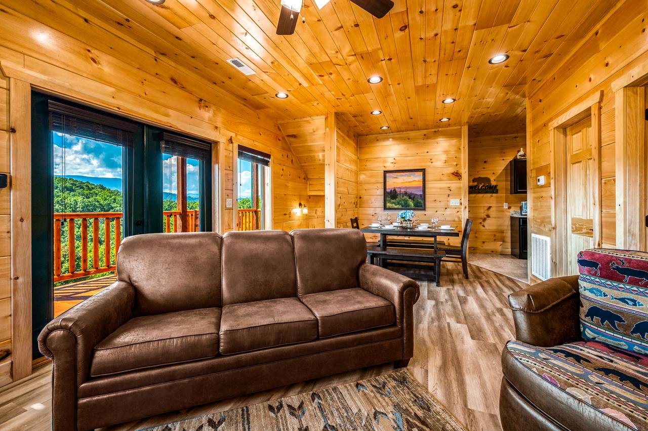 Spacious living room with fireplace, TV, & a queen sleeper sofa. Spacious living room with fireplace, TV, & a queen sleeper sofa.