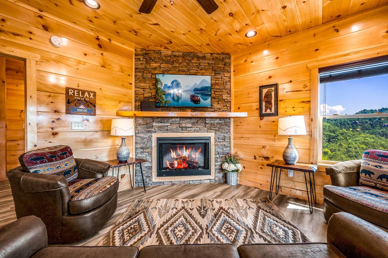 Spacious living room with fireplace, TV, & a queen sleeper sofa. Spacious living room with fireplace, TV, & a queen sleeper sofa.