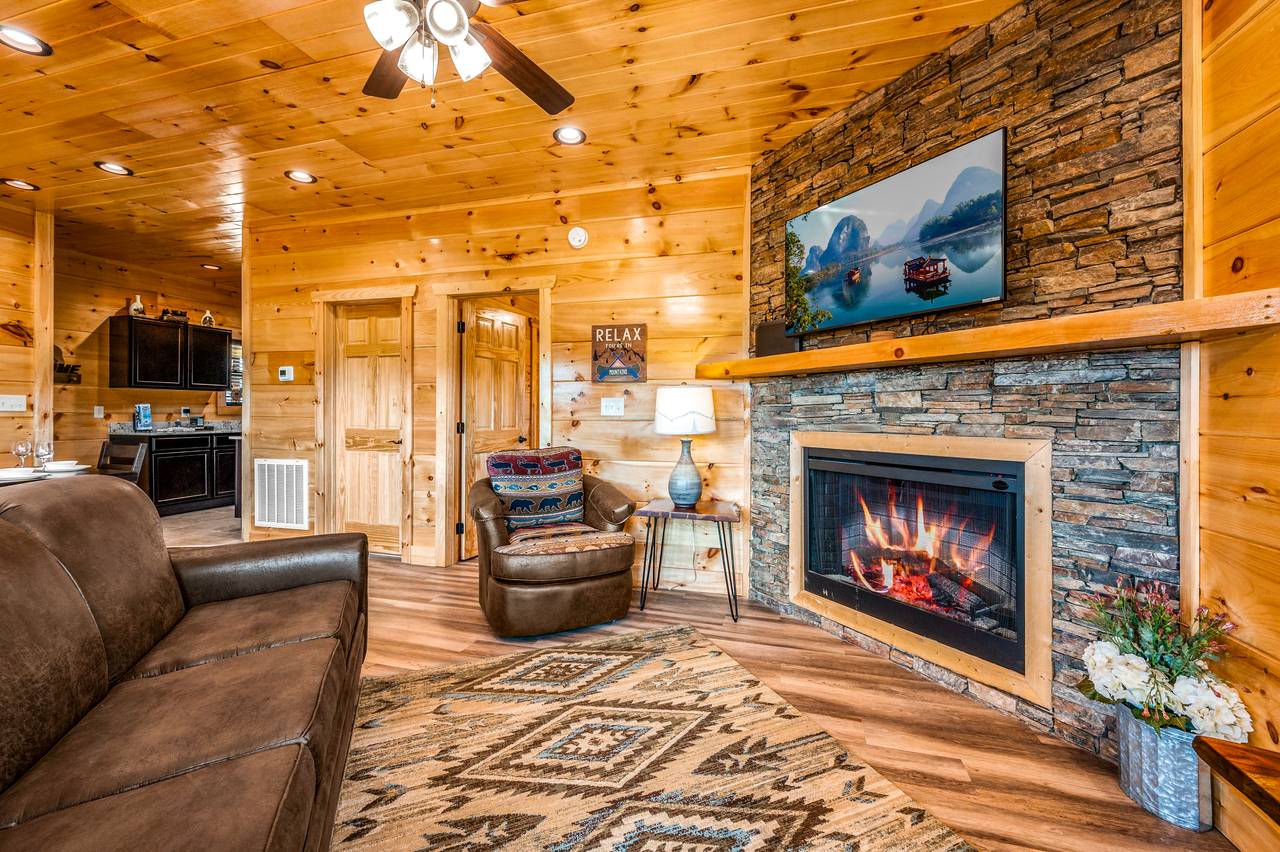 Spacious living room with fireplace, TV, & a queen sleeper sofa. Spacious living room with fireplace, TV, & a queen sleeper sofa.