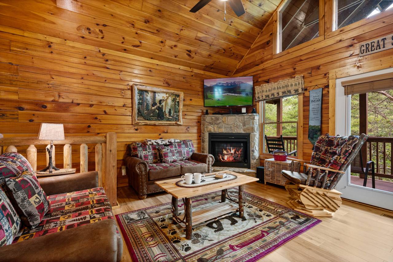 Living room with fireplace, TV, couch, loveseat, and glider Living room with fireplace, TV, couch, loveseat, and glider