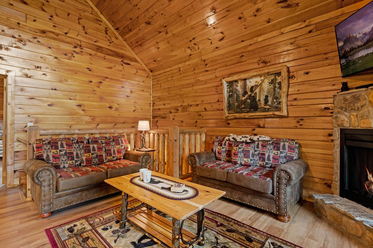 Living room with fireplace, TV, couch, loveseat, and glider Living room with fireplace, TV, couch, loveseat, and glider